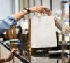 Manos de una mujer sosteniendo una bolsa de compra luego de que se activara los gatillos mentales