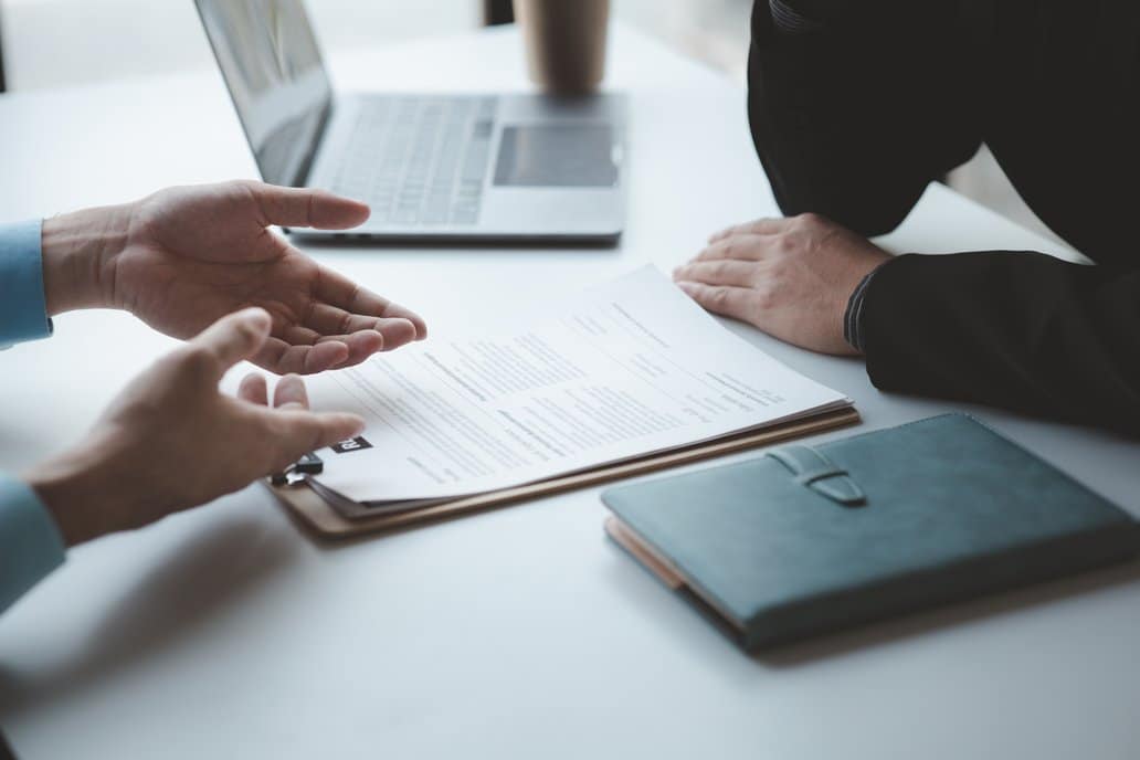 Agente explicando a un cliente qué es un microcrédito y cómo se diferencia de un minicrédito